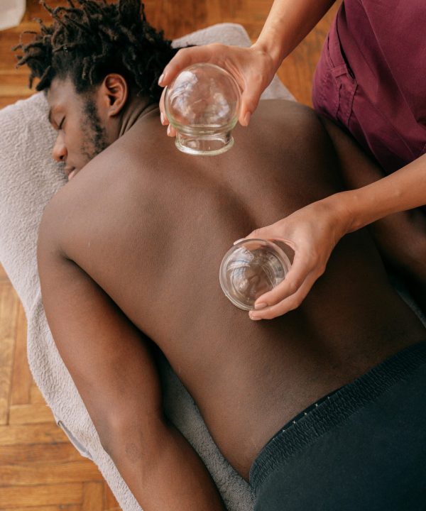 Man receiving traditional cupping therapy for relaxation and muscle tension relief.